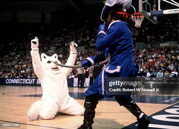 Team mascots get playful during break in the action as the Seton Hall Pirate prepares to draw and quarter Jonathan, the University of Connecticut...