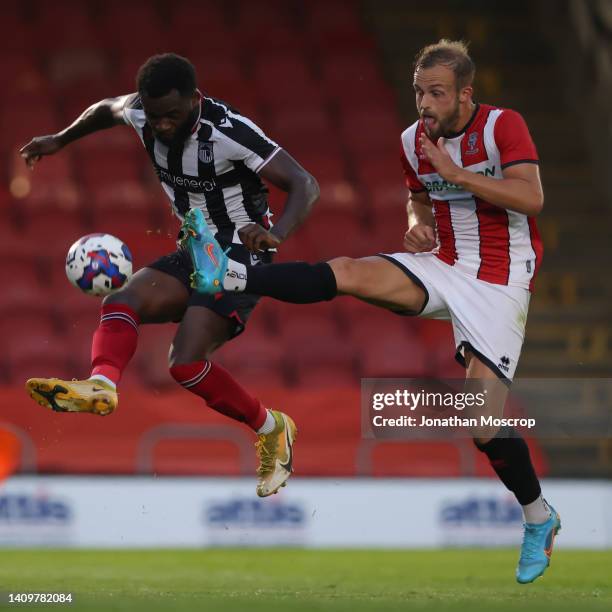 Charles Vernam of Lincoln City challenges Miche Efete of Grimsby Town during the Pre-Season Friendly between Grimsby Town FC and Lincoln City at...