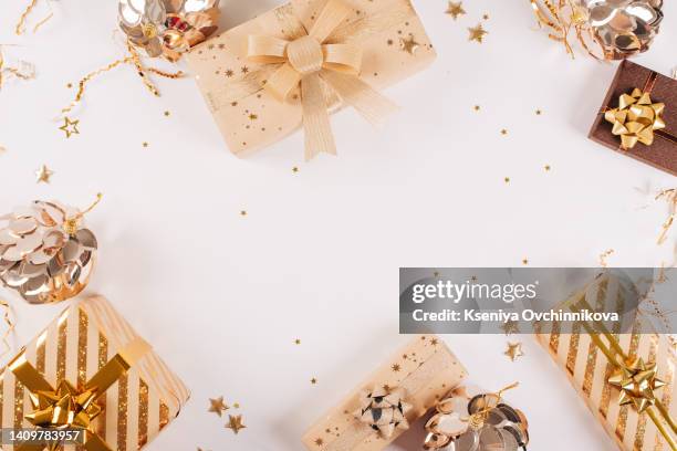 happy new year banner. christmas design gold gifts box, golden balls, glitter confetti stars on white background. decoration objects viewed from above. - geometric border stock pictures, royalty-free photos & images