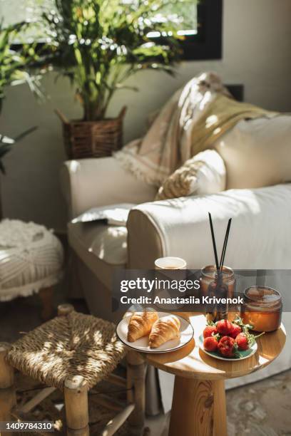 book with cup of coffee and croissants on wooden table. - 雰囲気 ストックフォトと画像