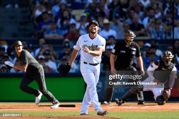 Clayton Kershaw of the Los Angeles Dodgers reacts after a single by Shohei Ohtani of the Los Angeles Angels in the first inning during the 92nd MLB...