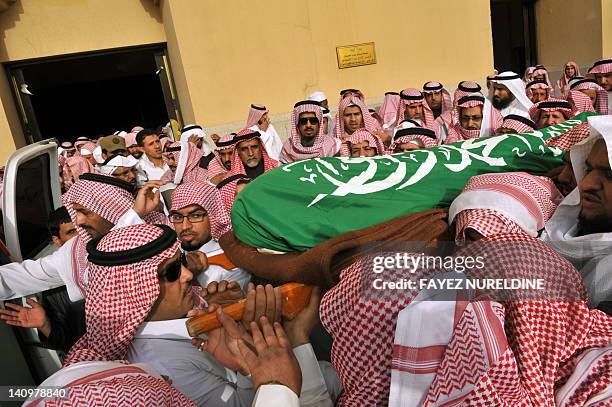 Relatives and friends of Saudi diplomatic Khalaf Al-Ali, the second secretary at the Saudi Arabian embassy in Bangladesh, carry his body during his...