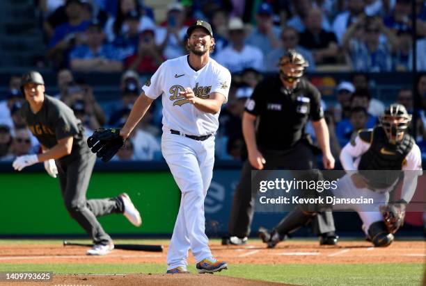 Starting pitcher Clayton Kershaw of the Los Angeles Dodgers reacts after giving up a hit to Shohei Ohtani of the Los Angeles Angels during first...