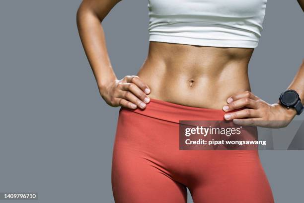 body shape of an asian woman with abdominal muscles. - asian female bodybuilder stock-fotos und bilder