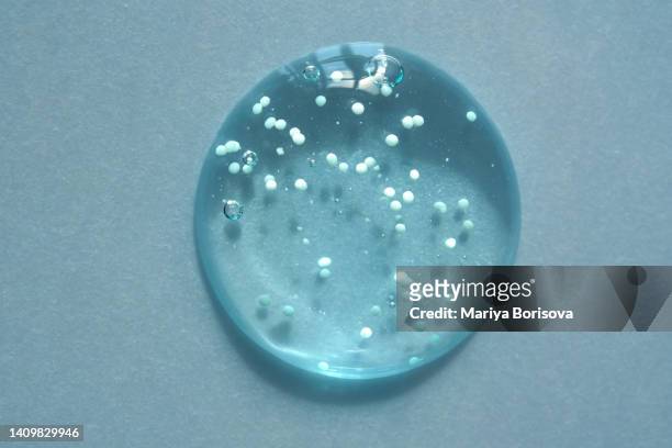 a drop of turquoise booster gel with microcapsules of vitamins. - peptídeo imagens e fotografias de stock