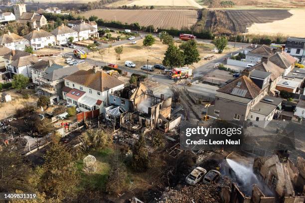 An aerial view shows the rubble and destruction in a residential area following a large blaze the previous day, on July 20, 2022 in Wennington,...