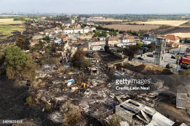 An aerial view shows the rubble and destruction in a residential area following a large blaze the previous day, on July 20, 2022 in Wennington,...