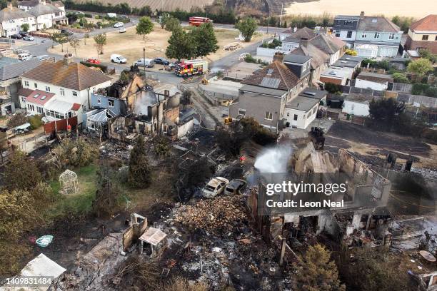 An aerial view shows the rubble and destruction in a residential area following a large blaze the previous day, on July 20, 2022 in Wennington,...