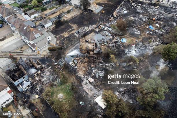 An aerial view shows the rubble and destruction in a residential area following a large blaze the previous day, on July 20, 2022 in Wennington,...