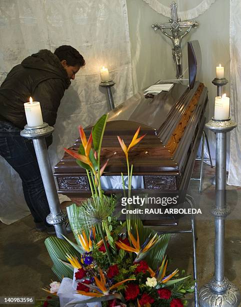 Relative of miner Victor Quiceno, killed in the flood that ripped through inside a coal mine, attends his funeral in the municipality of Angelopolis,...