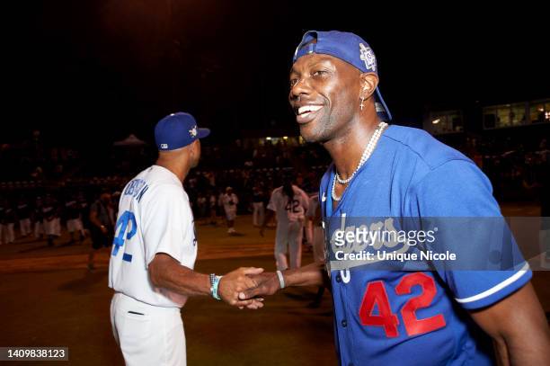 Terrell Owens celebrates the end of a game on the field at the Bumpboxx Honors 75th Anniversary Of Jackie Robinson Breaking The Color Barrier With...