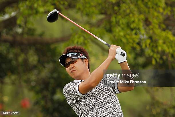 Tadahiro Takayama of Japan watches his tee shot on the fifth hole during first round of the World Golf Championships-Cadillac Championship on the TPC...