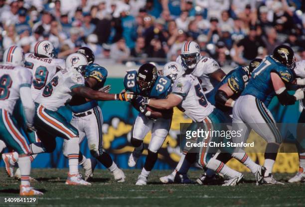 James Stewart, Running Back for the Jacksonville Jaguars runs the football through the Miami Dolphins defence during the American Football Conference...