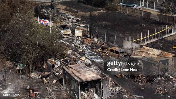 An aerial view shows a Union Flag flying among the the rubble and destruction in a residential area, following a large blaze the previous day, on...