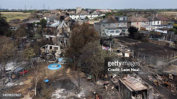 An aerial view shows a Union Flag flying among the the rubble and destruction in a residential area, following a large blaze the previous day, on...