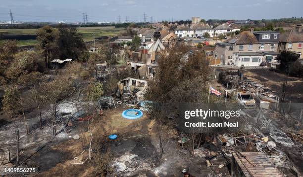 An aerial view shows a Union Flag flying among the the rubble and destruction in a residential area, following a large blaze the previous day, on...