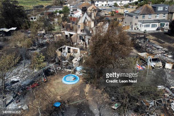 An aerial view shows a Union Flag flying among the the rubble and destruction in a residential area, following a large blaze the previous day, on...