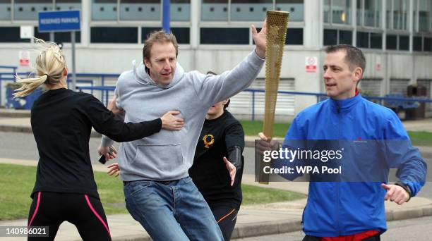 Men stage an attack during a training session for the Olympic Torch Security Team who will be protecting the torch bearers and Olympic flame during...