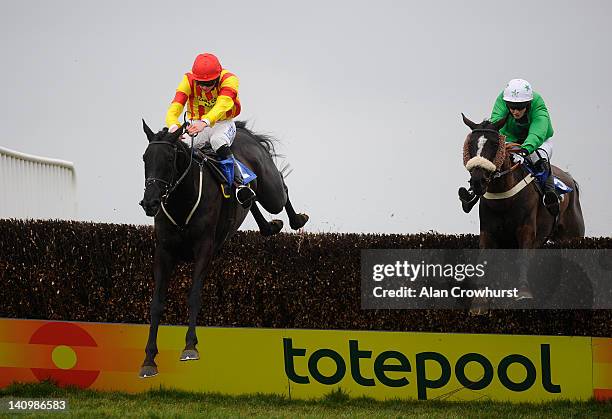 Andrias Guerin riding Hobb's Dream clear the last to win The Grolsch Handicap Steeple Chase from William Twiston-Davies riding Kilvergan Boy at...