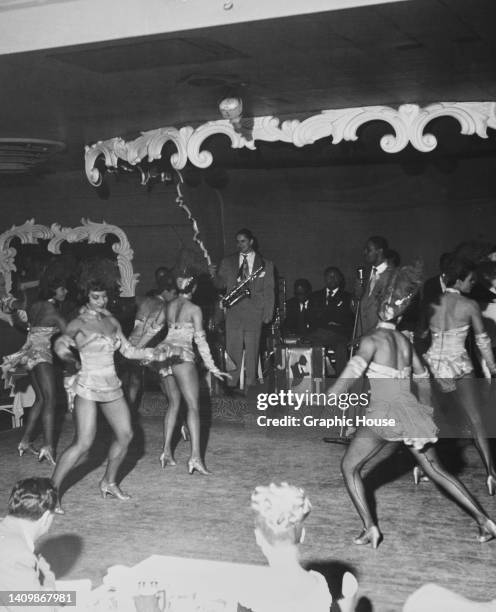 Chorus girls, known as the "Beige Beauts", perform to a live band playing at the Cotton Club, Miami Beach, Florida, US, circa 1950.