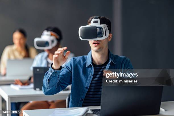university students using virtual reality headset in the classroom - virtual library stock pictures, royalty-free photos & images