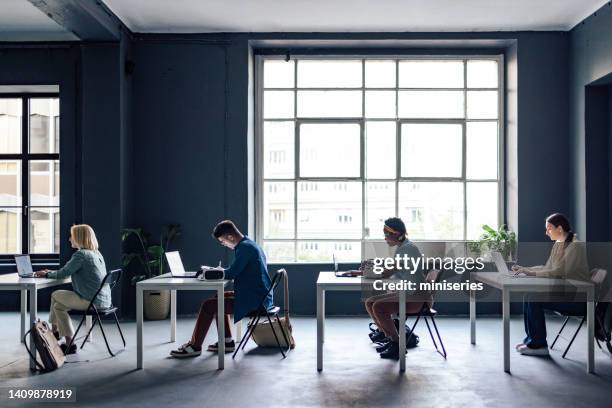 university students taking notes while sitting in the classroom - virtual library stock pictures, royalty-free photos & images
