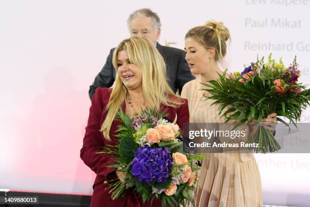 Corinna Schumacher, wife of former Formula One champion Michael Schumacher and her daughter Gina Schumacher with Jean Todt react at the awarding of...