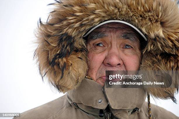 Sammy John, Sr., watches the activity at the checkpoint in Nikolai, Alaska, during the Iditarod Trail Sled Dog Race on Tuesday, March 6, 2012.