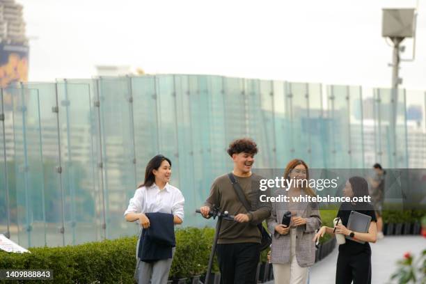 group of business person relaxing together at public park in the green city. - step well stockfoto's en -beelden