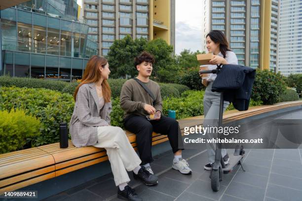 group of business person relaxing together at public park in the green city. - step well stockfoto's en -beelden