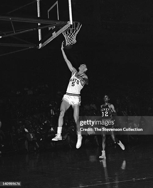 Paul Neumann of the Syracuse Nationals shoots against Lenny Wilkens of the St. Louis Hawks circa 1962 at the Onondaga War Memorial Arena in Syracuse,...