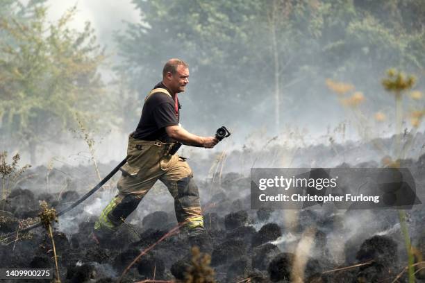 Firefighters contain a wildfire that encroached on nearby homes in the Shiregreen area of Sheffield on July 20, 2022 in Sheffield, England. Multiple...