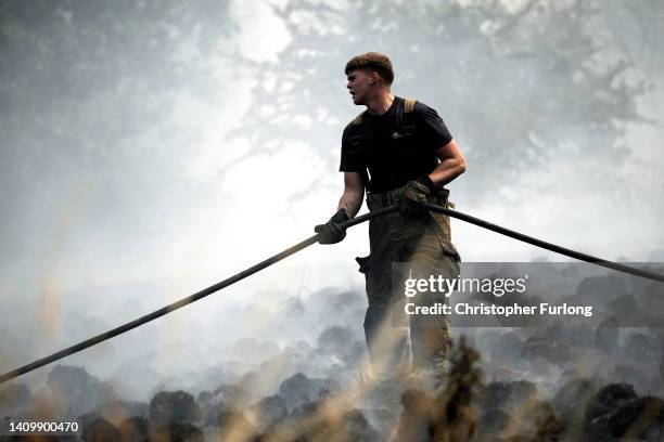 Firefighters contain a wildfire that encroached on nearby homes in the Shiregreen area of Sheffield on July 20, 2022 in Sheffield, England. Multiple...