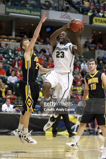 Draymond Green of the Michigan State Spartans drives for a shot attempt in the first half against Josh Oglesby of the Iowa Hawkeyes during their...