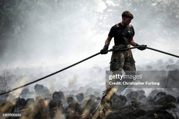 Firefighters contain a wildfire that encroached on nearby homes in the Shiregreen area of Sheffield on July 20, 2022 in Sheffield, England. Multiple...