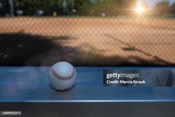 baseball on the dugout bench of a local park - dugout baseball stock pictures, royalty-free photos & images