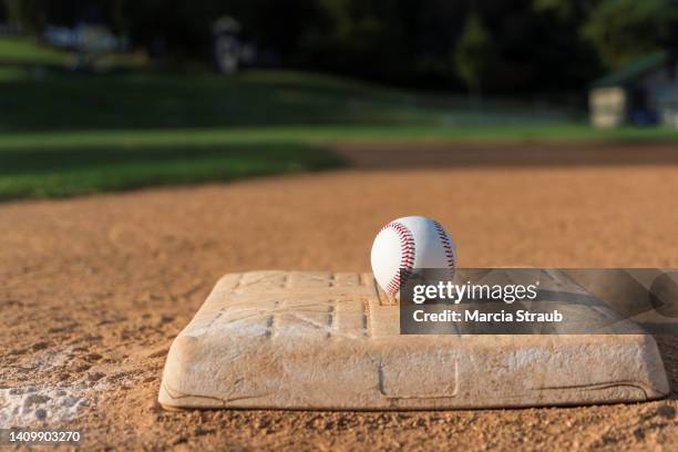 baseball on infield  base - baseball base stock-fotos und bilder