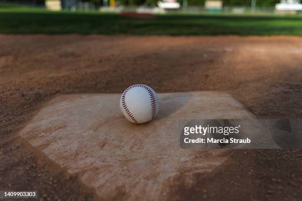 baseball on home base - baseball field background stock pictures, royalty-free photos & images