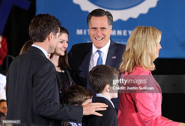 Republican presidential candidate, former Massachusetts Gov. Mitt Romney arrives at a Super Tuesday night gathering with his family on March 6, 2012...