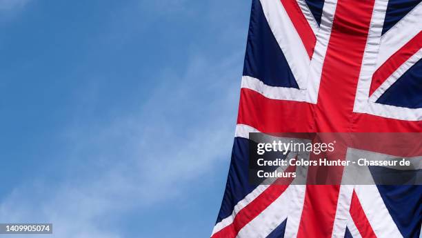 close-up of united kingdom flag against blue sky in london, england, uk - referendum stock pictures, royalty-free photos & images