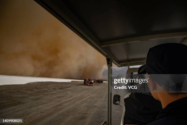 Shuttle vehicle carrying tourists runs at the Emerald Lake tourist attraction in Da Qaidam Town during a sandstorm on July 20, 2022 in Da Qaidam...