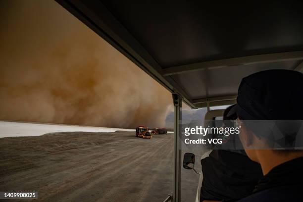 Shuttle vehicle carrying tourists runs at the Emerald Lake tourist attraction in Da Qaidam Town during a sandstorm on July 20, 2022 in Da Qaidam...