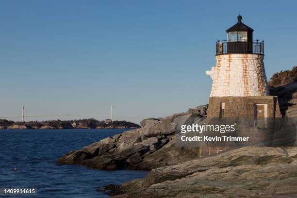 castle hill lighthouse with newport bridge during blue hour - rhode island bridge stock pictures, royalty-free photos & images