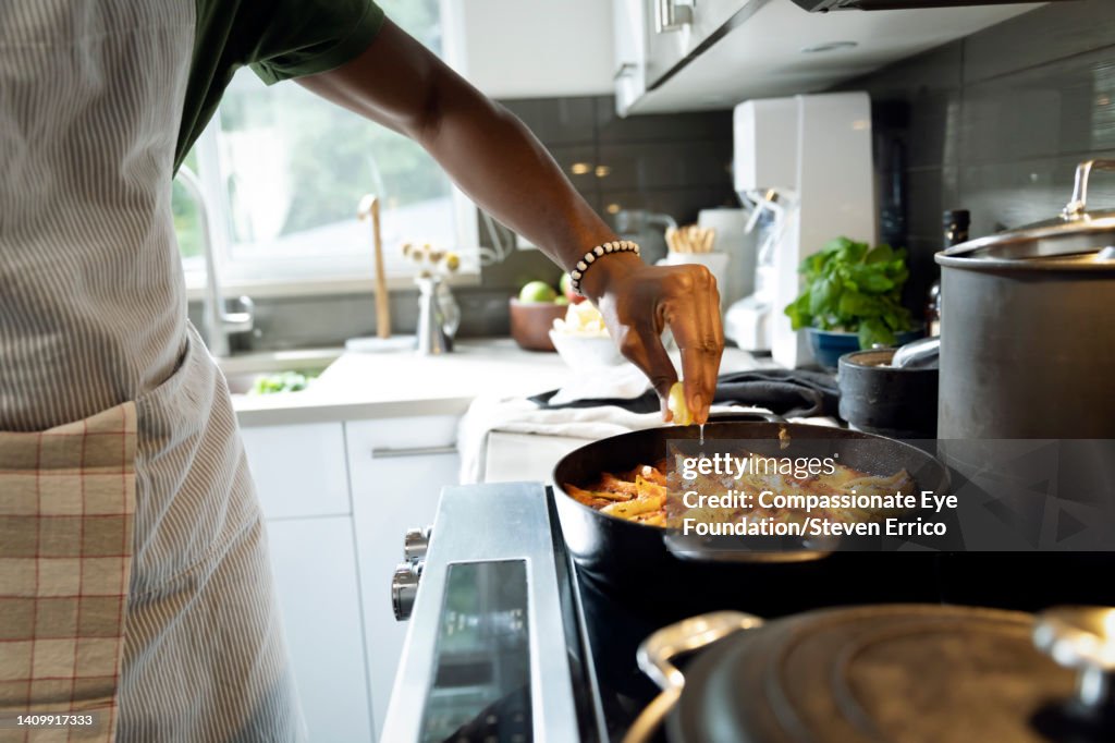 Close up of man cooking in kitchen