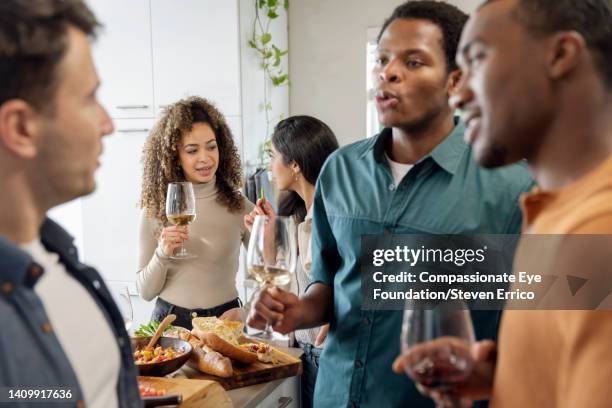 friends having social gathering at home - the blue man group in vancouver stock pictures, royalty-free photos & images