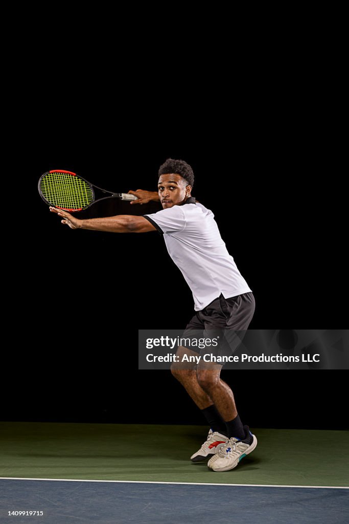 Tennis player preparing to hit a tennis ball.