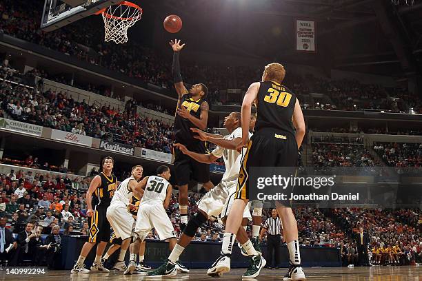 Roy Devyn Marble of the Iowa Hawkeyes attempts a shot against the Michigan State Spartans during their quarterfinal game of 2012 Big Ten Men's...