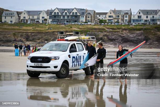 Lifeguard in a Ford Ranger truck, talks to surfers at Polzeath beach, on July 20, 2022 in Polzeath, United Kingdom.