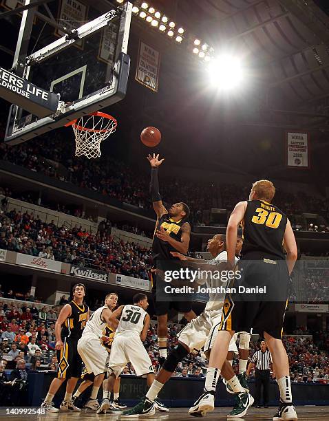 Roy Devyn Marble of the Iowa Hawkeyes attempts a shot against the Michigan State Spartans during their quarterfinal game of 2012 Big Ten Men's...