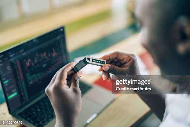 man at home using hardware wallet for cryptocurrency - token stock pictures, royalty-free photos & images